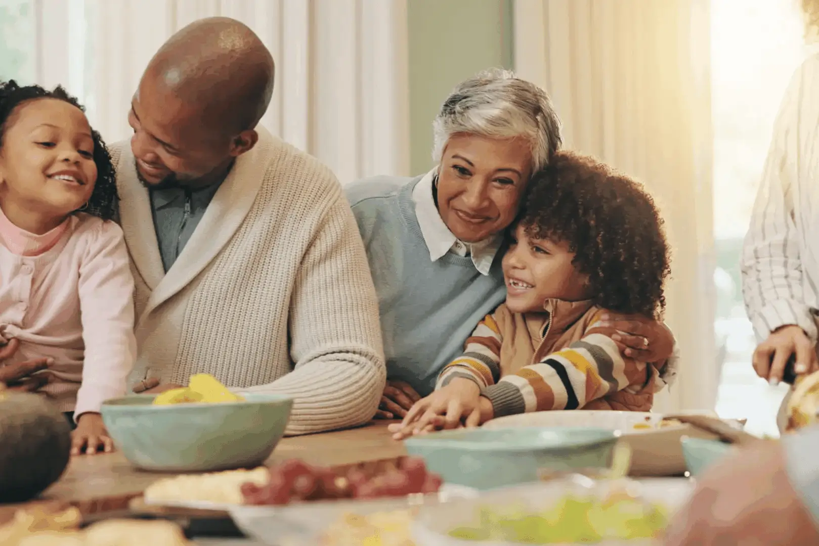 Family enjoying quality time and laughter around the dining table.